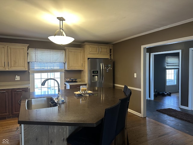 kitchen with crown molding, stainless steel fridge, a sink, and dark wood-style floors