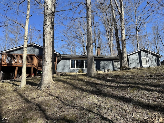 view of front of house with a chimney and a wooden deck