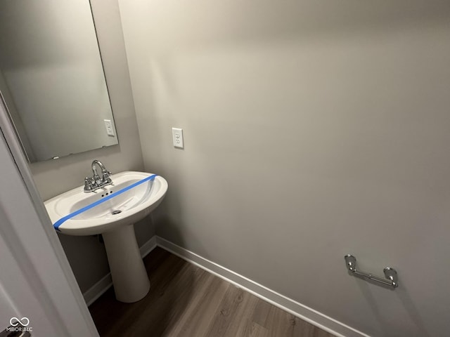 bathroom featuring wood finished floors and baseboards