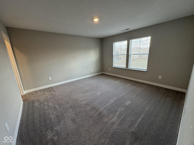 unfurnished room featuring carpet floors, baseboards, and visible vents