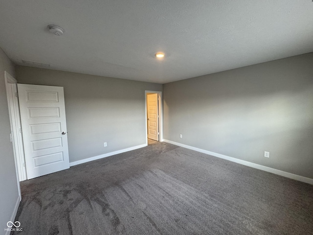 unfurnished room with carpet and baseboards