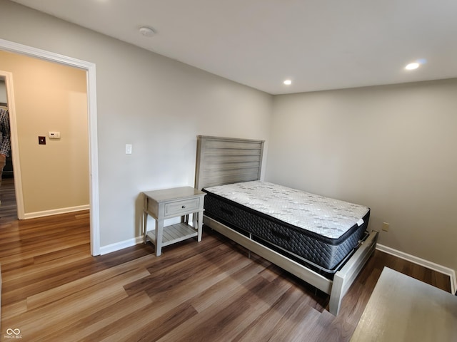 bedroom featuring recessed lighting, wood finished floors, and baseboards