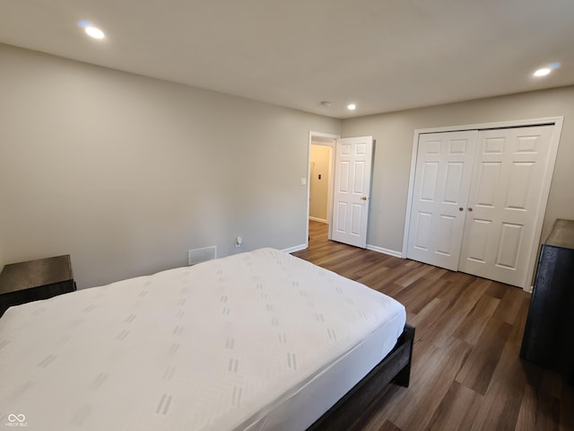 bedroom with dark wood-type flooring, recessed lighting, and visible vents