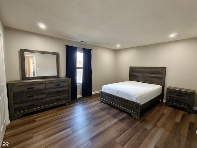 bedroom with recessed lighting, wood finished floors, and baseboards