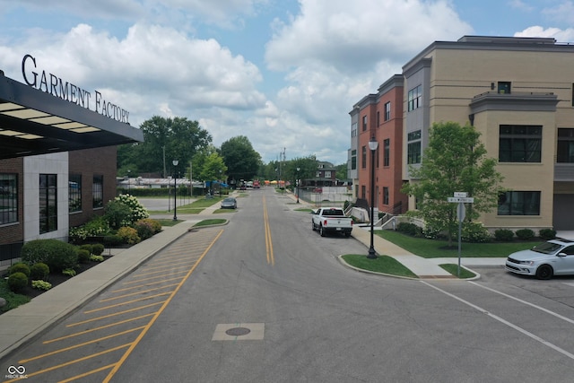 view of street featuring traffic signs, curbs, and sidewalks