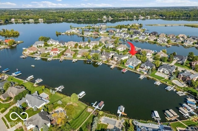 drone / aerial view featuring a residential view and a water view