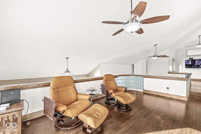 living area with lofted ceiling, wood finished floors, and an upstairs landing