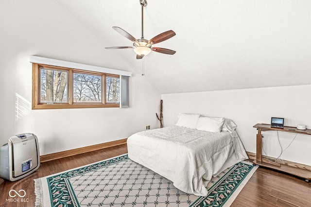 bedroom featuring lofted ceiling, a ceiling fan, baseboards, and wood finished floors