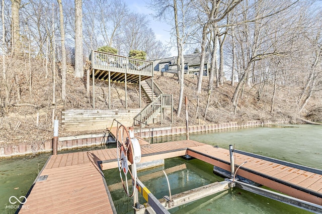 dock area with stairway and a water view