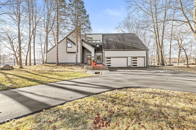 view of front of home featuring aphalt driveway and an attached garage