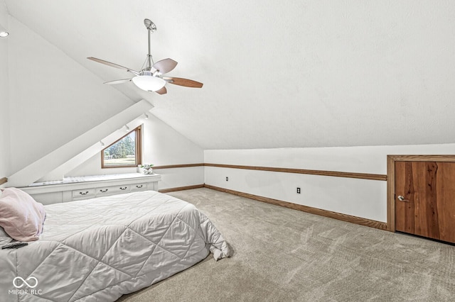 bedroom featuring vaulted ceiling, carpet flooring, a ceiling fan, and baseboards