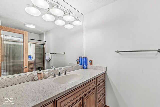 bathroom with a textured ceiling and vanity