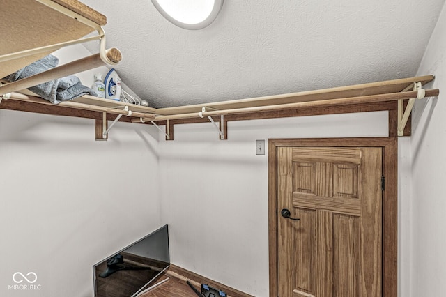 walk in closet featuring vaulted ceiling