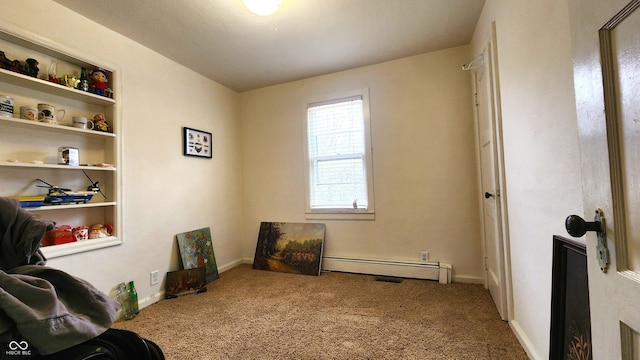 living area with a baseboard heating unit, baseboards, and carpet floors