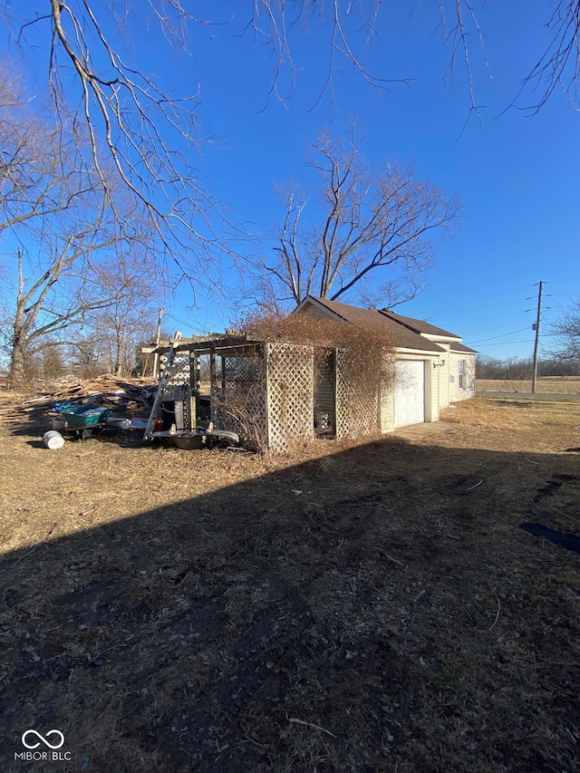 view of side of home with a garage and an outdoor structure