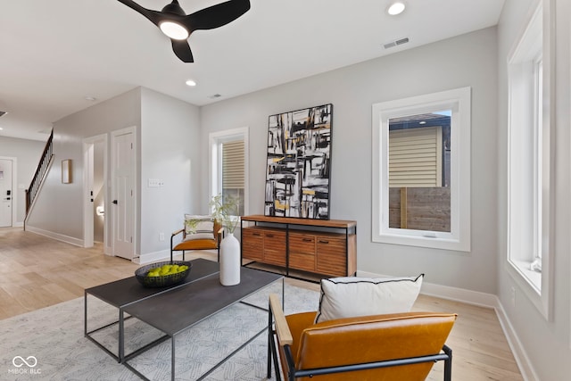 sitting room featuring stairway, recessed lighting, visible vents, and light wood-style floors