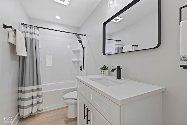 bathroom with toilet, recessed lighting, wood finished floors, vanity, and shower / bath combination with curtain