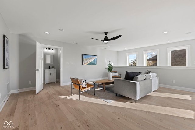 living area featuring recessed lighting, a ceiling fan, visible vents, baseboards, and light wood-type flooring