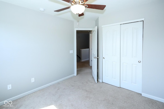 unfurnished bedroom with a ceiling fan, a closet, carpet flooring, and baseboards