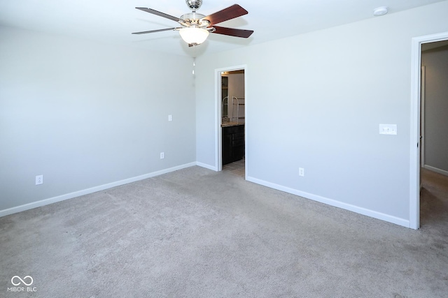 unfurnished bedroom featuring carpet, connected bathroom, baseboards, and ceiling fan