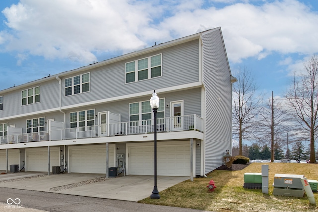 view of front facade with central AC, driveway, and an attached garage