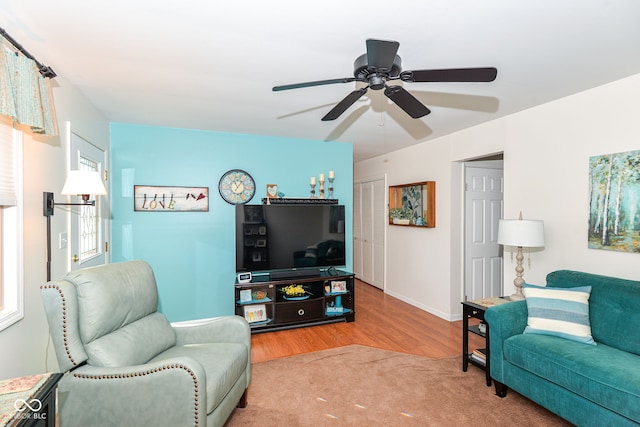 living room featuring wood finished floors and baseboards