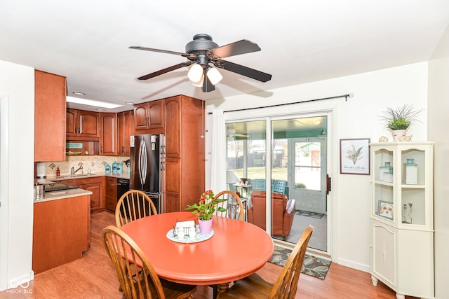 dining room featuring a ceiling fan and light wood-style flooring