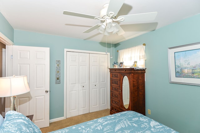 carpeted bedroom featuring a closet and ceiling fan