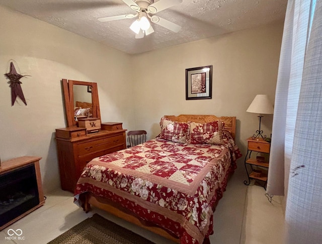 carpeted bedroom with a ceiling fan and a textured ceiling