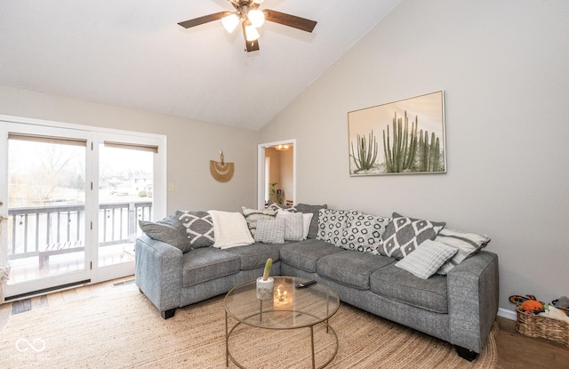 living room featuring light wood-style floors, high vaulted ceiling, and a ceiling fan