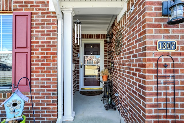 property entrance with brick siding