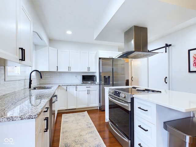 kitchen featuring island range hood, decorative backsplash, appliances with stainless steel finishes, dark wood-style flooring, and a sink