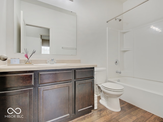 bathroom featuring vanity, tub / shower combination, wood finished floors, and toilet