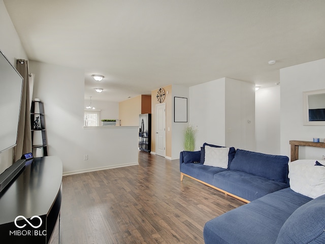 living room with baseboards and wood finished floors