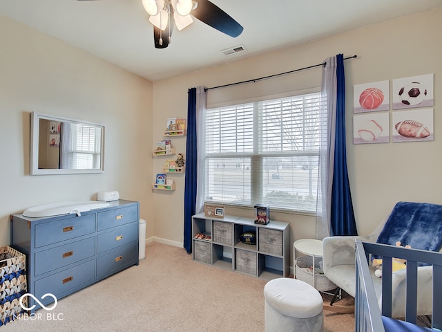 bedroom featuring light colored carpet, visible vents, ceiling fan, and baseboards