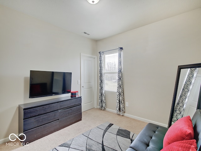 living room with baseboards, visible vents, and carpet flooring