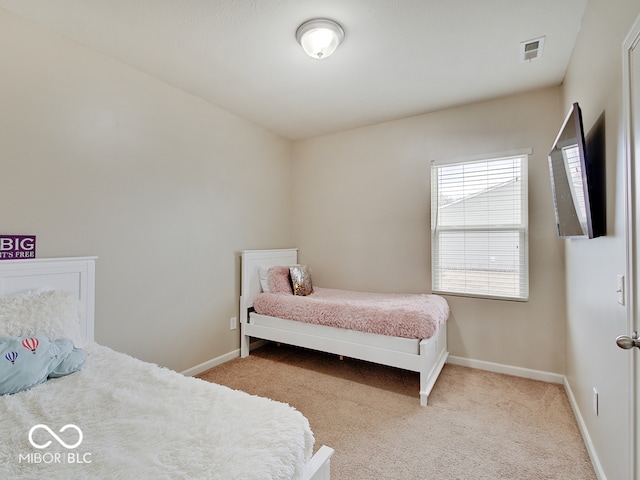 bedroom featuring light carpet, visible vents, and baseboards