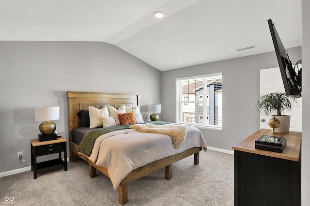 bedroom featuring baseboards, visible vents, light carpet, and lofted ceiling