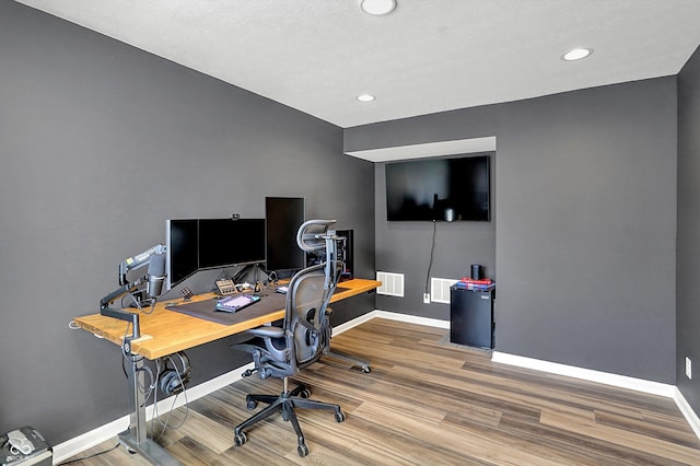 office space featuring visible vents, recessed lighting, baseboards, and wood finished floors