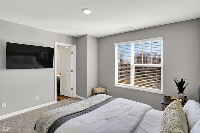 carpeted bedroom with baseboards