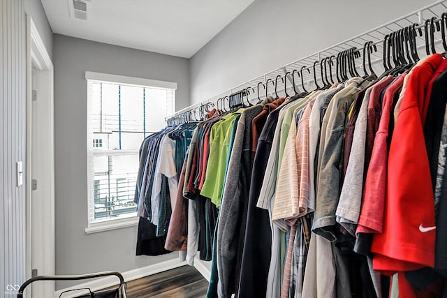 walk in closet with visible vents and wood finished floors