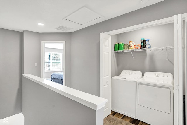 laundry room featuring visible vents, washer and clothes dryer, attic access, laundry area, and dark wood-style flooring