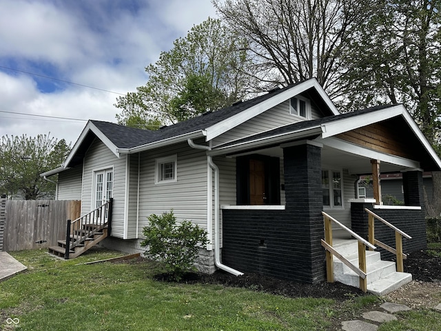 744 Wallace Ave, Indianapolis, IN 46201 - view of side of home with roof with shingles, a porch, and entry steps