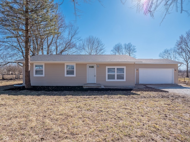 single story home with a garage, driveway, and a front yard