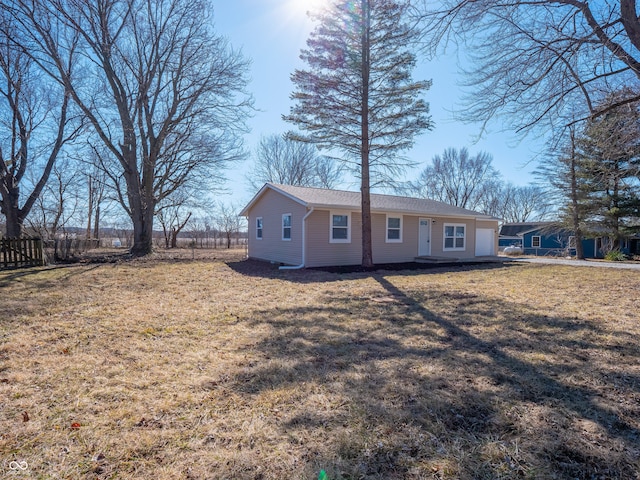 view of front of house with fence and a front lawn