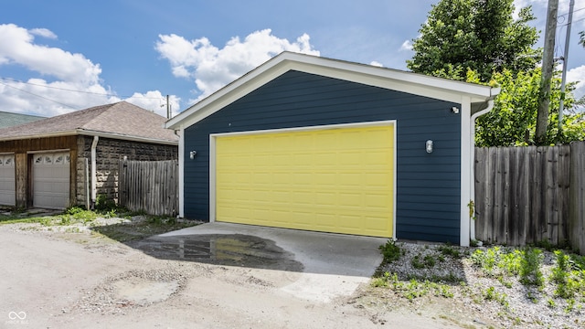 detached garage featuring fence