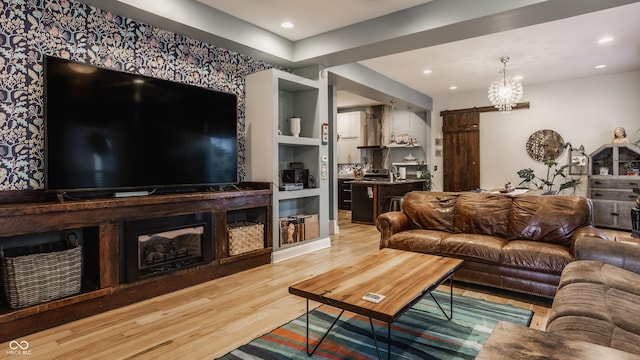 living room with an inviting chandelier, wood finished floors, and recessed lighting