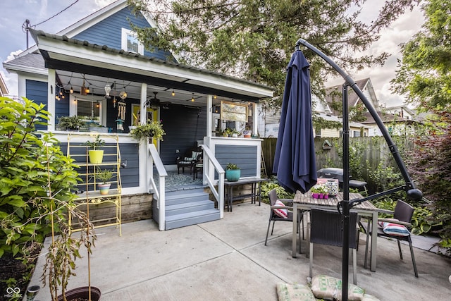 view of patio featuring ceiling fan, fence, and outdoor dining area