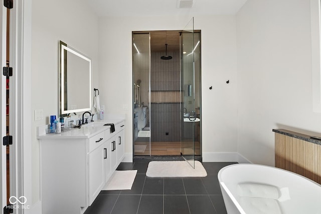 bathroom with a freestanding bath, a stall shower, vanity, tile patterned floors, and radiator