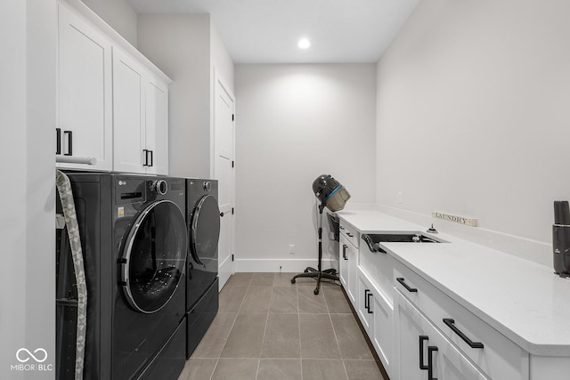 laundry area with cabinet space, baseboards, recessed lighting, light tile patterned flooring, and washer and clothes dryer